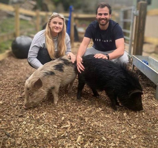 Sam White And Emily Pridham with their micro pigs in Slough. See Animal News copy AN-CostPig: Thrifty Brits are choosing to keep their money in the PIGGY BANK by adopting a micro pig rather than a dog. With the cost of living crisis set to deepen in the Autumn, many people are looking at different cheaper ways to welcome a new pet into their lives. A recent study found that keeping a dog can cost up to £250 a month, and with the nation being forced to tighten its belt due to rising fuel and living costs, many feel priced out of new pet ownership entirely. WWW.ANIMALNEWSAGENCY.COM - 0044 (0)7494818329