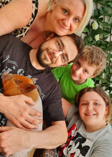 Lisa and Mark Thomas with children Olivia and Oscar with their micro pig buscuit who lives in Worcestershire.  See Animal News copy AN-CostPig: Thrifty Brits are choosing to keep their money in the PIGGY BANK by adopting a micro pig rather than a dog. With the cost of living crisis set to deepen in the Autumn, many people are looking at different cheaper ways to welcome a new pet into their lives. A recent study found that keeping a dog can cost up to £250 a month, and with the nation being forced to tighten its belt due to rising fuel and living costs, many feel priced out of new pet ownership entirely. WWW.ANIMALNEWSAGENCY.COM - 0044 (0)7494818329